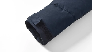 Detail view of dark blue windproof jacket cuff featuring adjustable velcro strap