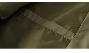 Detail of high-density olive green polyester fabric with precise single-needle stitching