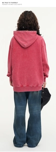 Rear view of heavy 425g washed red hoodie with loose drop shoulder and denim pants