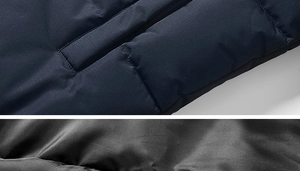 Detail of dark blue quilted outdoor jacket with windproof fabric and smooth black zipper