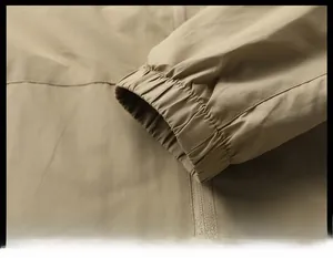 Detail of elastic cuff on men's khaki outdoor jacket with high-quality windproof fabric texture