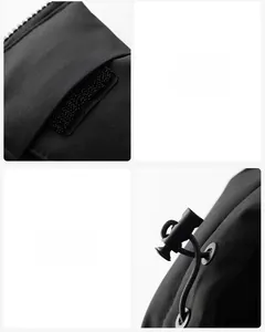 Detail of windproof black jacket featuring adjustable velcro cuffs and elastic drawstring
