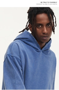 Detail view of heavy 425g washed blue hoodie with vintage texture and drop shoulders
