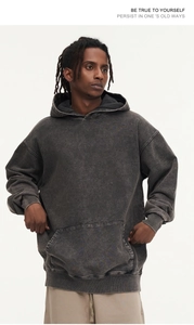 Detail of oversized 425g cotton hoodie featuring washed texture and motivational text