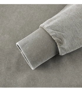 Detailed close-up of ribbed cuffs and vintage washed cotton texture on heavy hoodie