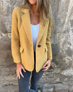 Detail of ginger yellow wool coat with notched lapel and single button closure