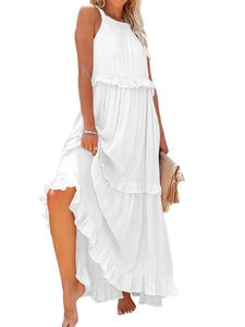 Detail of white tiered ruffle maxi dress with spaghetti straps in a bohemian summer style