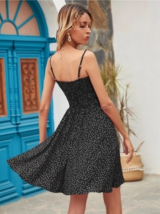 Back view of summer polka dot mini dress featuring thin straps and pleated back details