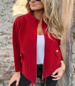 Close-up of red tweed wool jacket with metal zipper and decorative button pockets