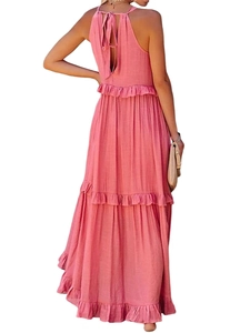 Back view of pink tiered halter maxi dress featuring bow tie and textured fabric details