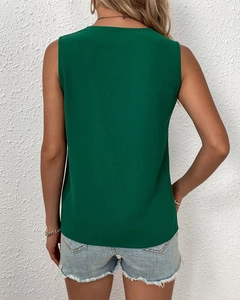 Back view of a sleeveless dark green blouse with textured fabric and V-neckline detail