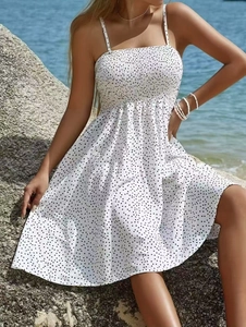 Detail of white polka dot sundress with elastic pleated bust and A-line skirt