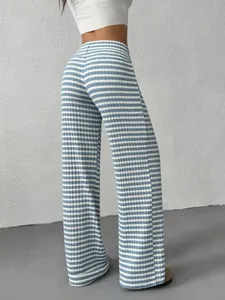 Macro detail of the vertical knit texture on blue and white striped high waist flare pants