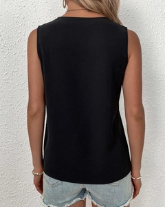 Rear view of a sleeveless black v-neck top with lace trim in a loose casual style