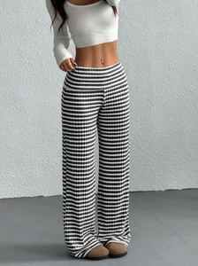 Close-up of high-waist striped wide-leg trousers in elastic ribbed knit fabric