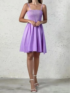 Detail of purple floral summer mini dress with smocked chest and spaghetti straps