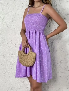 Detail of purple polka dot mini dress with smocked bodice and thin spaghetti straps
