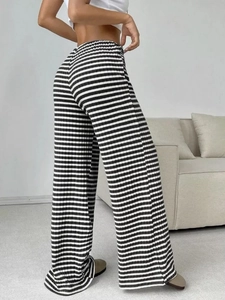 Detail view showing textured black and white striped knit fabric of high-waist pants