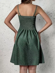 Detail of the smocked elastic back on the dark green polka dot bohemian summer dress