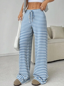 Detail of blue and white striped wide leg trousers with elastic drawstring waistband