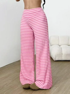 Detailed macro view of pink and white vertical ribbed fabric texture on flare pants