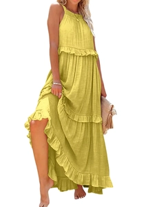 Detail of bohemian yellow halter neck tiered dress showing ruffled layers and cotton fabric