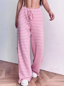 Detail of pink and white striped wide leg trousers with ribbed texture and drawstring waist