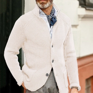 Detail view of the waffle knit texture and standing collar on this cream cardigan jacket