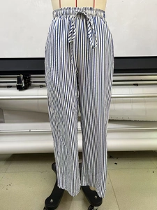 Detail of blue and white vertical striped wide-leg pants with elastic drawstring waistline