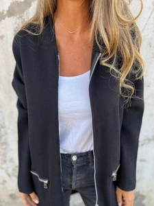 Front close-up of a black zip-up knit jacket featuring silver zippers and side pockets