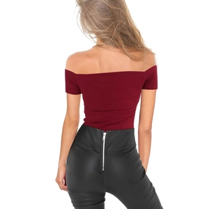 Detail view of burgundy off-shoulder top with high waist faux leather pants and back zipper