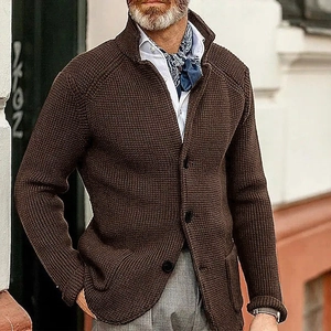 Detail of dark brown cable-knit cardigan with stand-up collar and button closure