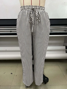 Detailed close-up of vertical striped wide leg pants with elastic drawstring waistband