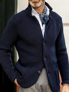Detail of men's navy blue waffle knit cardigan with high texture and buttoned pockets