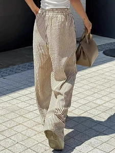 Vertical striped wide leg trousers with elastic waist and brown leather handbag detail