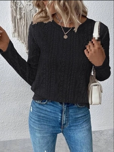 Detail view of black long sleeve shirt featuring intricate geometric hollow knit patterns
