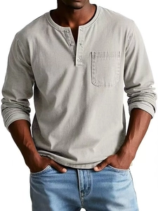 Detail of grey Henley shirt showing buttoned neckline, chest pocket, and cotton texture