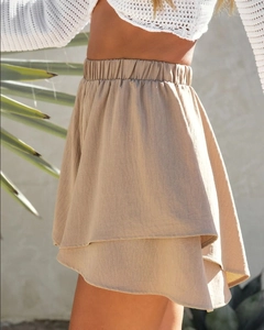 Detail of khaki layered ruffle shorts with high elastic waistband in outdoor setting