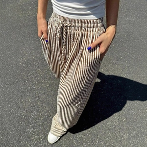 Women's vertical striped wide leg pants with drawstring waist and textured seersucker fabric