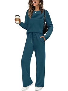 Detailed view of teal two-piece lounge set with pleated top and high waist wide leg pants