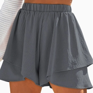 Detail view of dark grey layered ruffle hem and elastic high waist of casual shorts