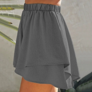 Detail of dark gray high-waisted culottes with layered ruffles and textured fabric