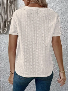 Detail of white short sleeve top featuring wave-patterned hollow lace back design