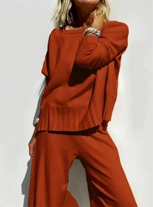 Detailed texture of brick red knit sweater set featuring vertical striped hem and loose fit