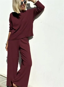 Detail of burgundy knitted set showing fine ribbed texture and elegant loose-fit design