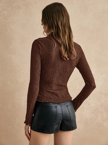 Detailed view of dark brown crinkle texture fabric on a slim-fit long-sleeve shirt