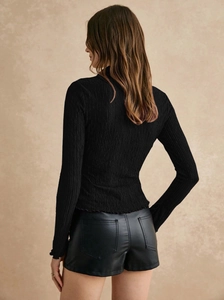 Detailed back view of a slim-fit black long-sleeved shirt with vertical pleated texture