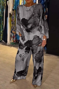 Detail of elegant two-piece satin set featuring black and white artistic ink floral prints