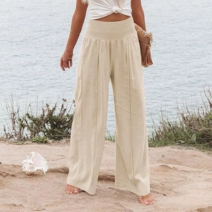Gros plan du pantalon large en lin beige avec taille haute élastiquée plissée