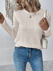 Detailed close-up of white lace hollow-out texture on bohemian style long sleeve shirt